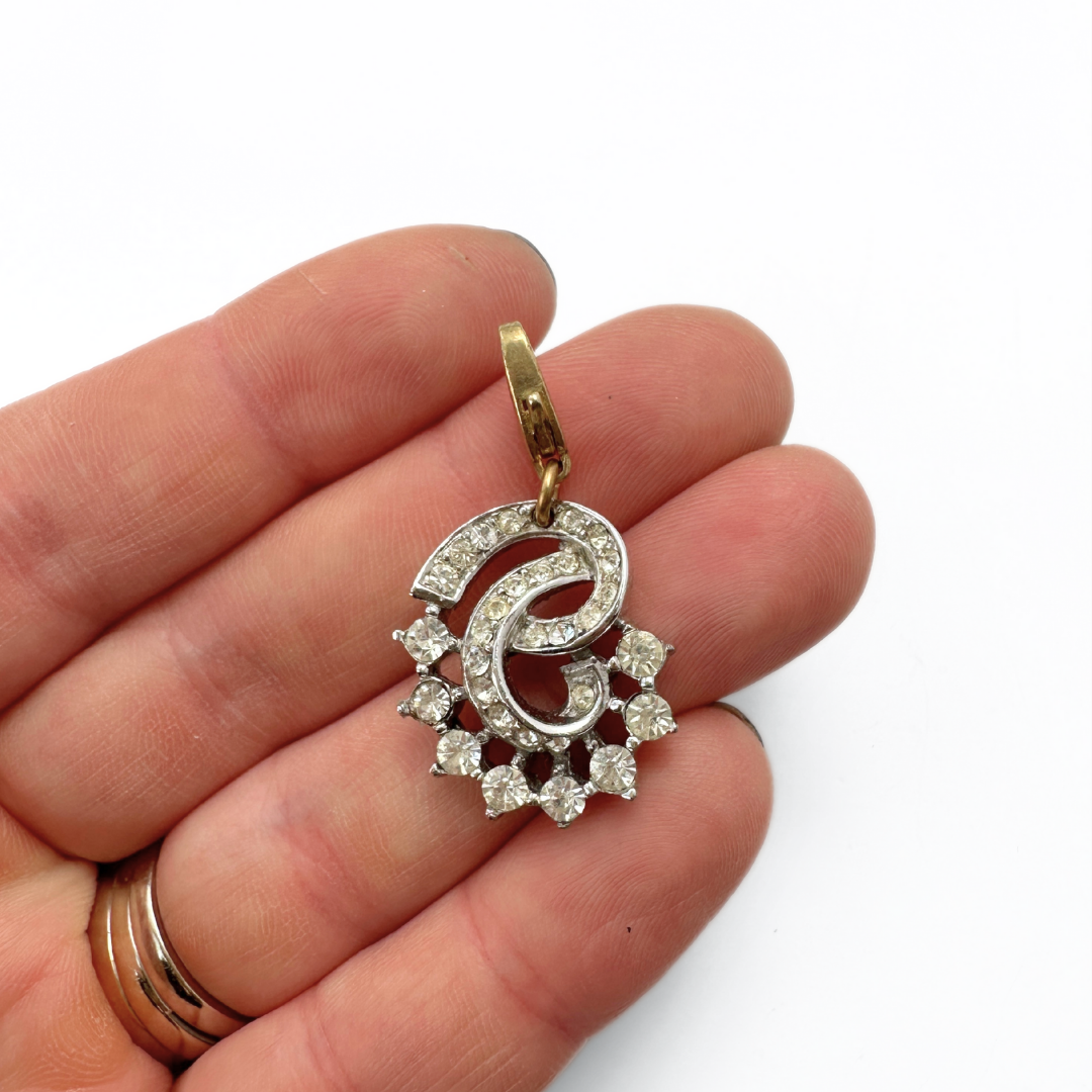 Vintage silver and clear rhinestone swirl charm