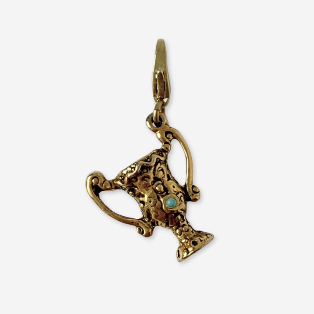 Vintage aged gold trophy charm with turquoise stone