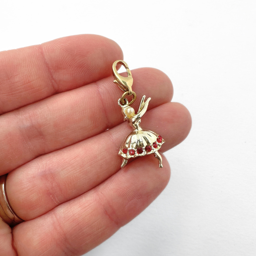 Vintage shiny gold dancer charm with red rhinestones