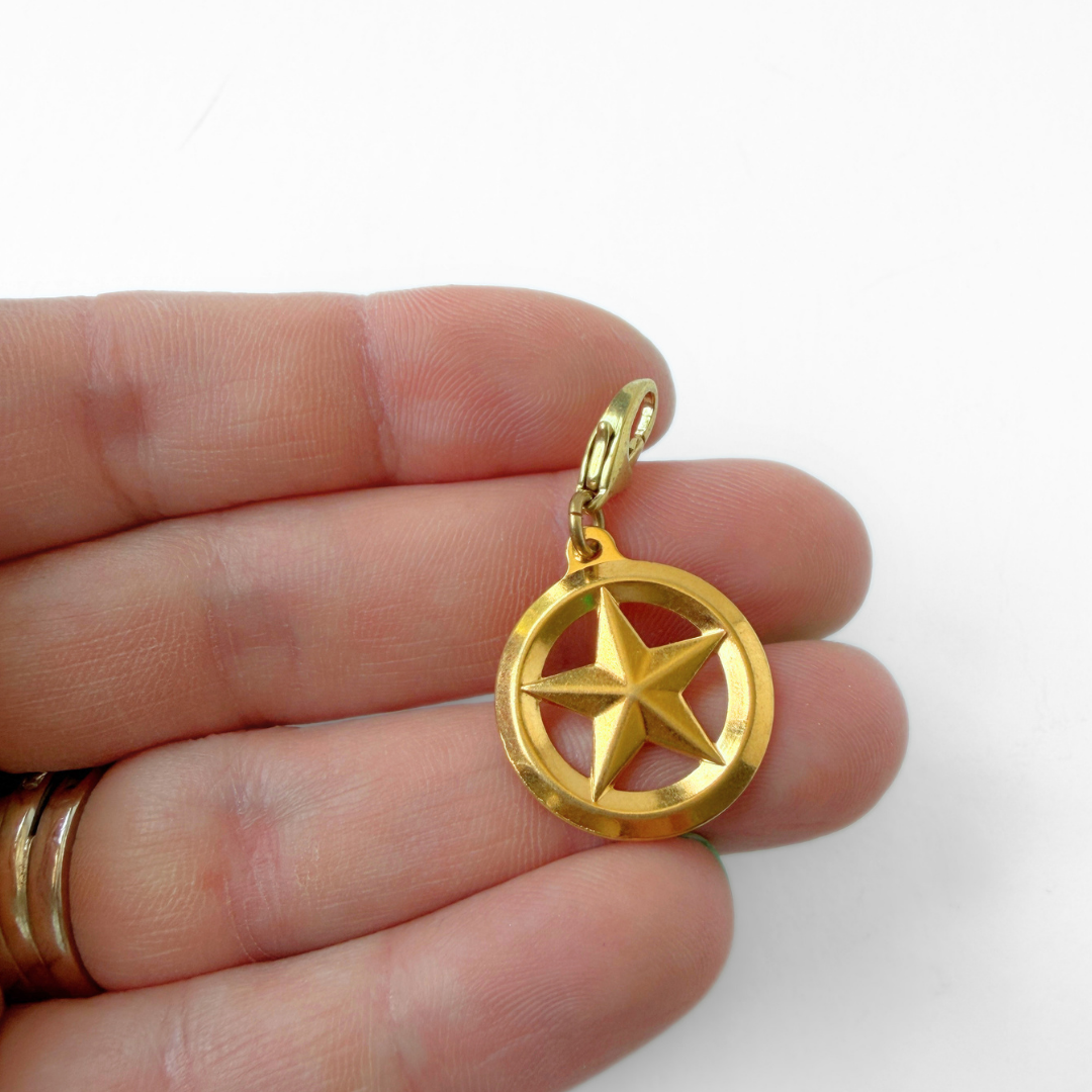 Vintage small gold plated circular star charm