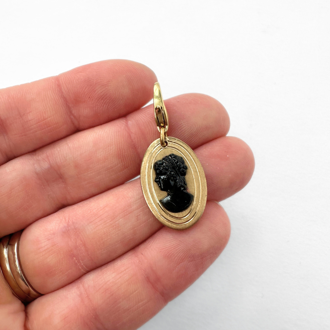 Vintage gold plated oval charm with black cameo silhouette