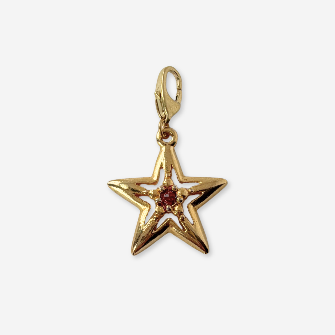 Vintage small gold plated star charm with red center