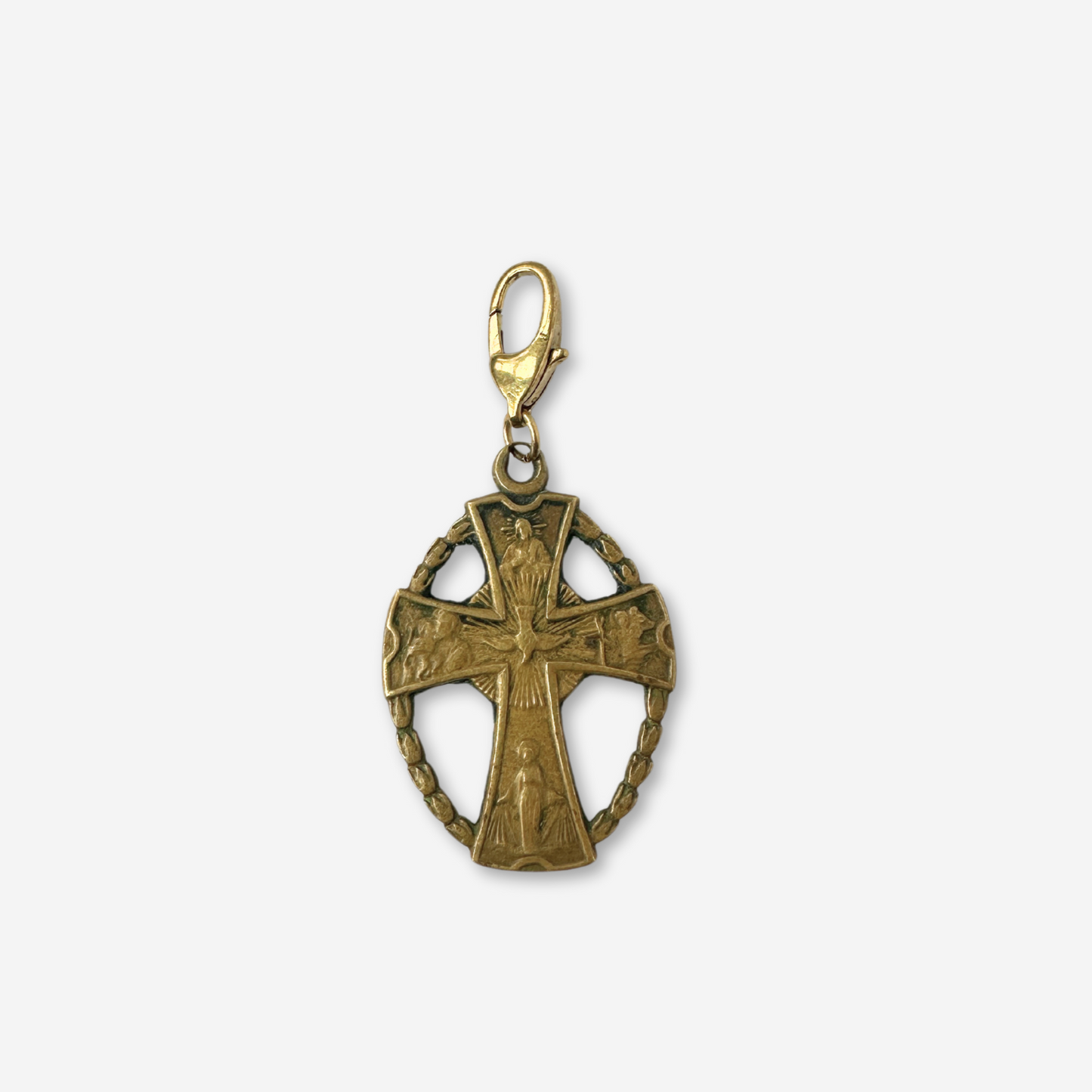 Vintage aged brass four-way cross charm with oval frame