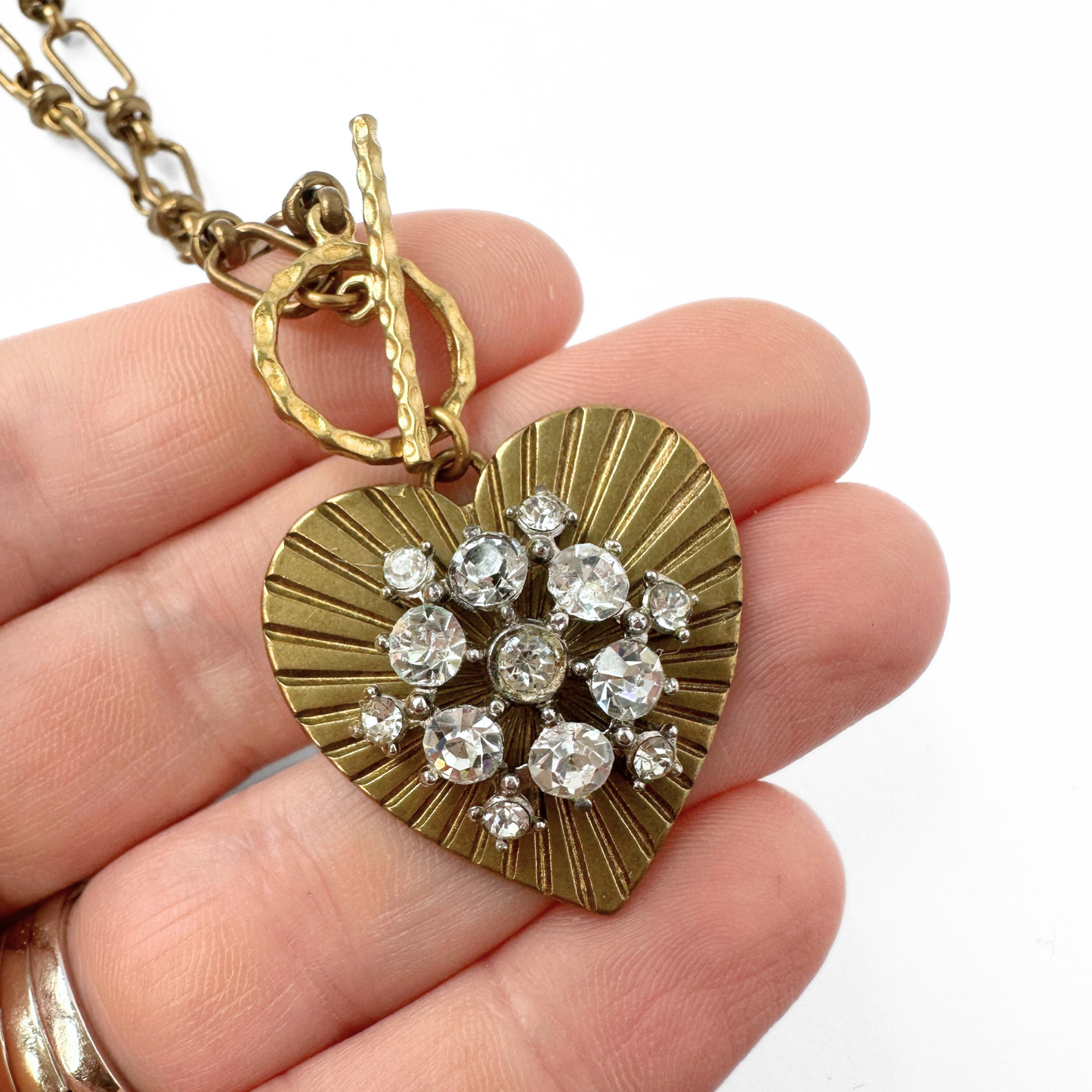 Large solid brass heart pendant with vintage clear rhinestone embellishment on brass toggle chain