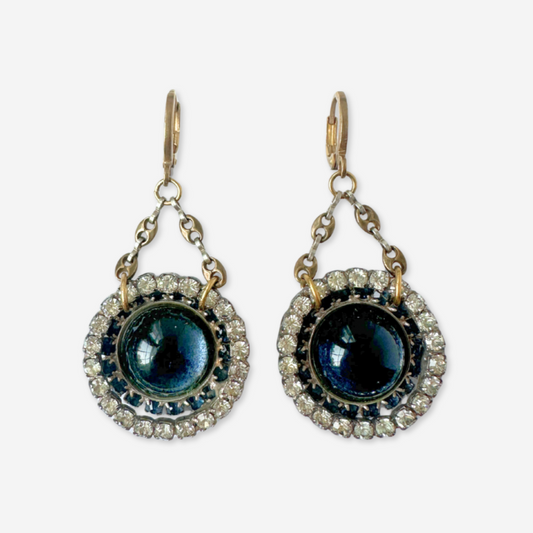 Pair of earrings with blue gemstones and gold accents on a white background