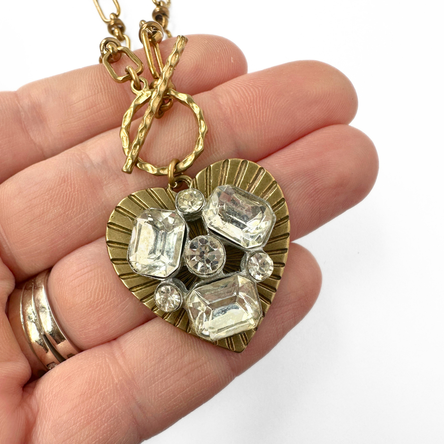 Large solid brass heart pendant with vintage clear rhinestone embellishment on brass toggle chain