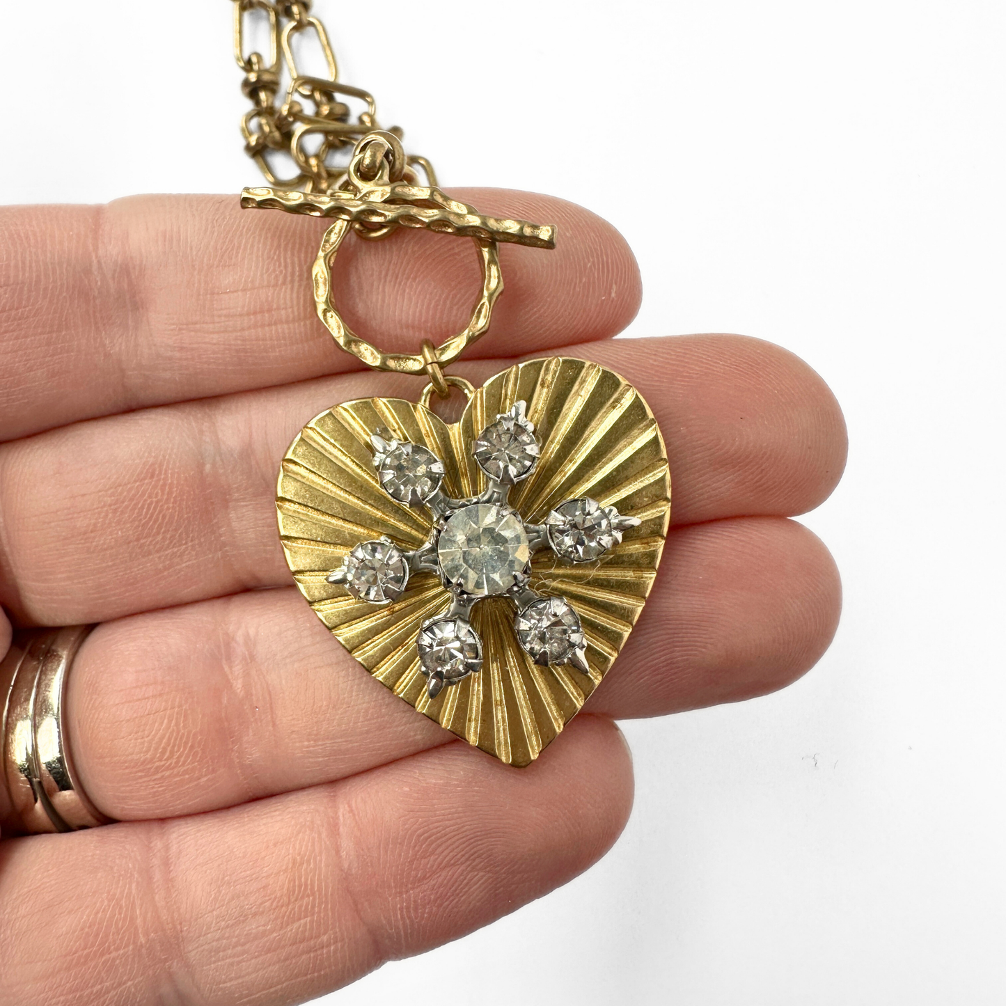 Large solid brass heart pendant with vintage clear rhinestone embellishment on brass toggle chain