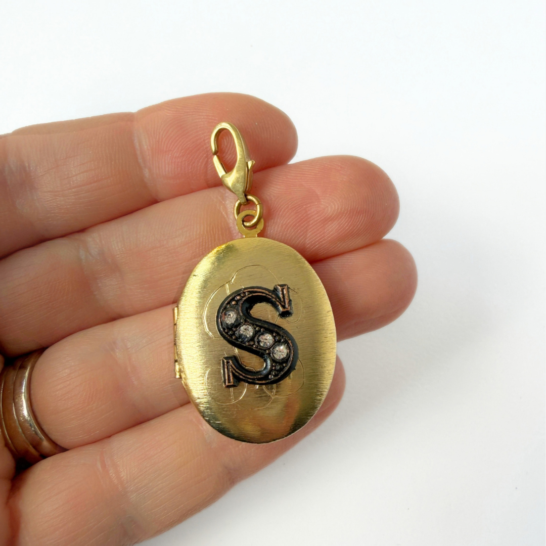 Vintage brass oval locket charm with black rhinestone letter "S"