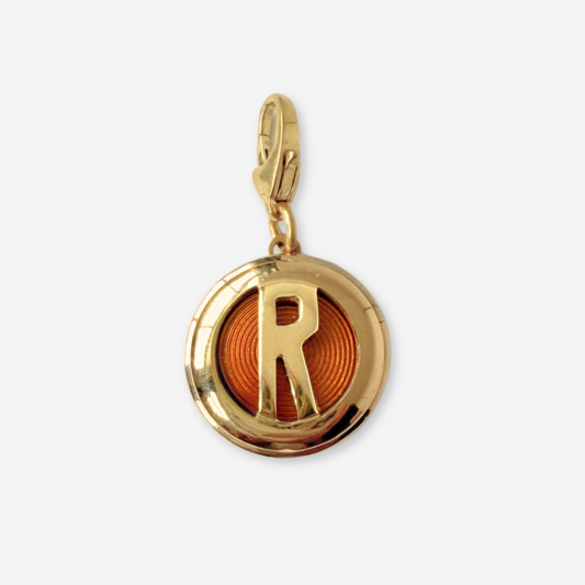 Vintage circular gold and amber enamel letter "R" charm