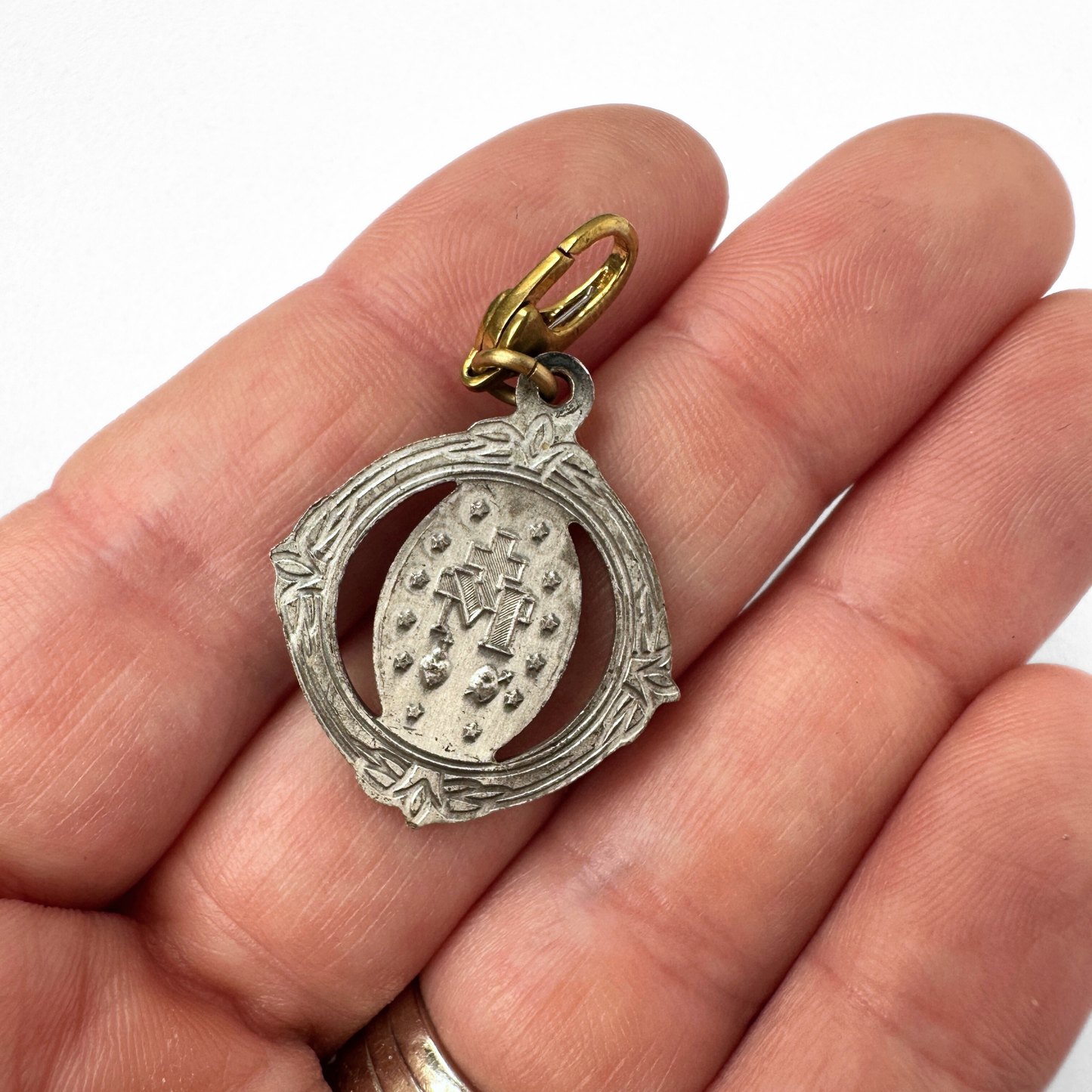 Vintage silver tone ornate miraculous medal charm with brass clasp