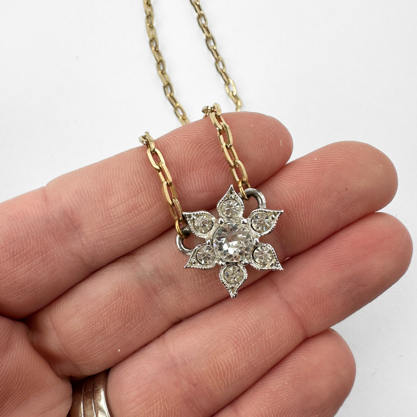 Small clear vintage rhinestone flower pendant on thin gold plated chain