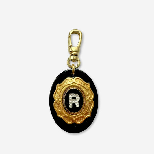 Vintage letter "R" black and brass layered oval charm