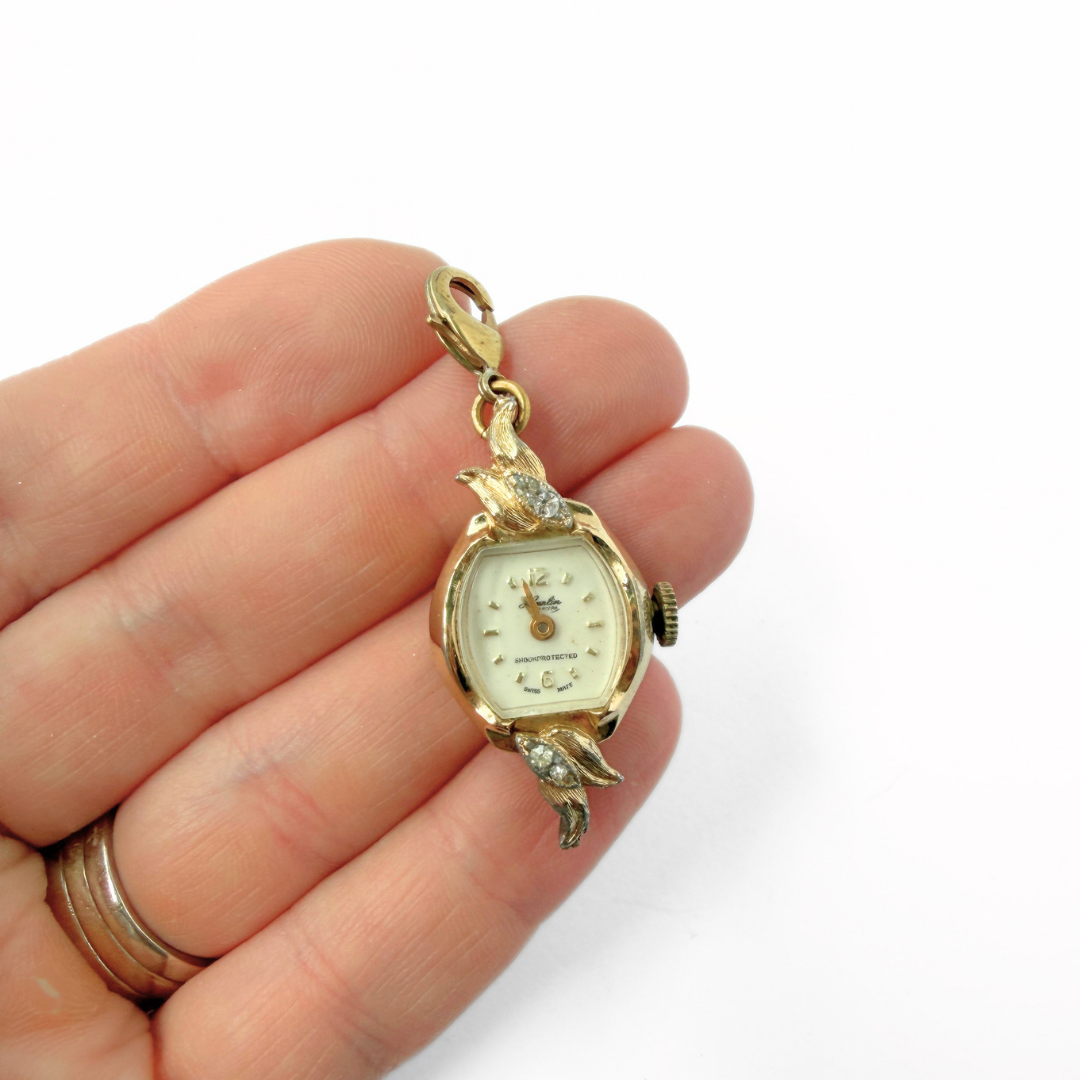 Vintage gold tone Swiss watch face charm