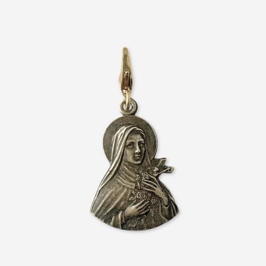 Medal pendant featuring a religious figure on a white background