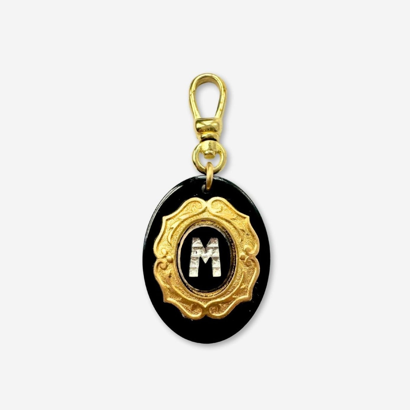 Vintage letter "M" black and brass layered oval charm