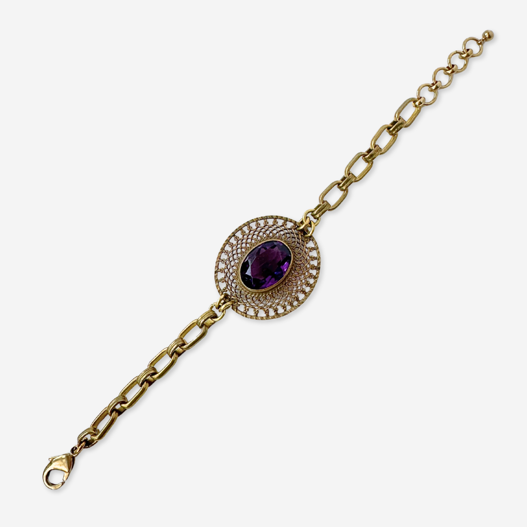 Repurposed antique oval filigree bracelet with purple glass centerpiece
