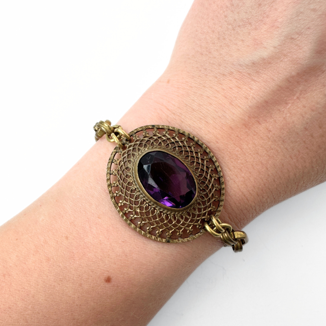 Repurposed antique oval filigree bracelet with purple glass centerpiece