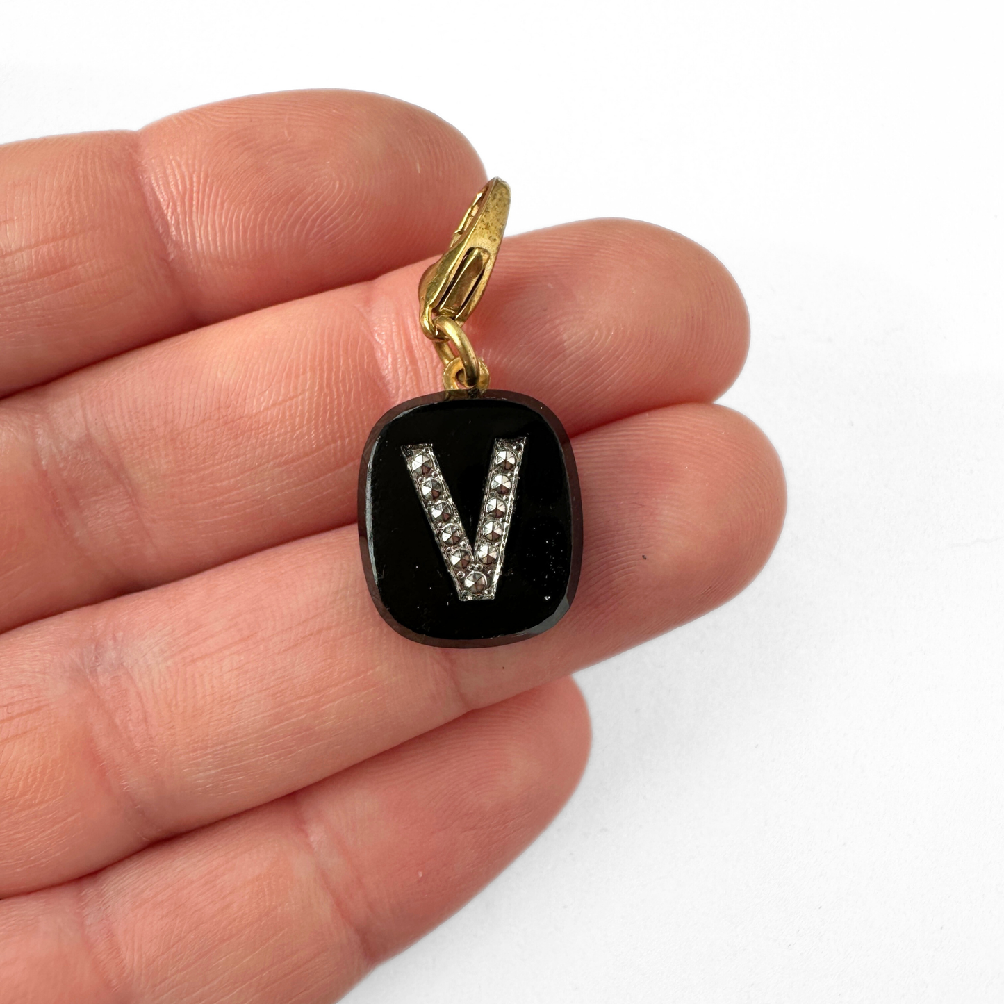 Vintage black glass letter "V" charm