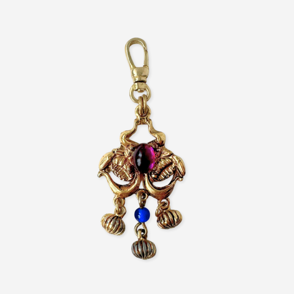 Vintage gold tone pendant charm with blue and purple gemstones