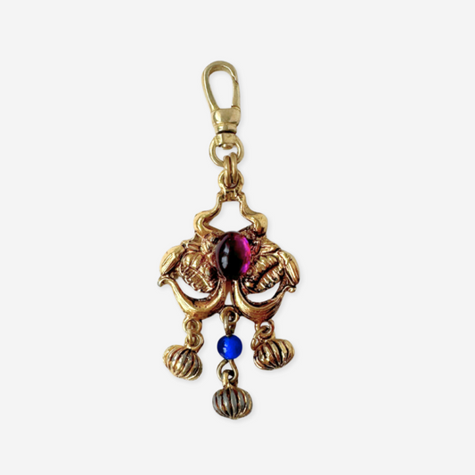 Vintage gold tone pendant charm with blue and purple gemstones