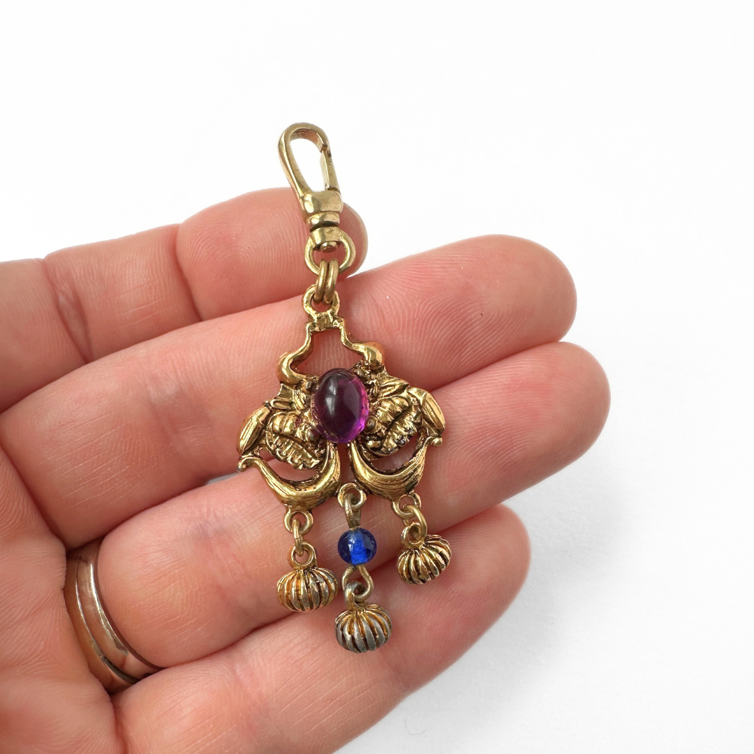 Vintage gold tone pendant charm with blue and purple gemstones