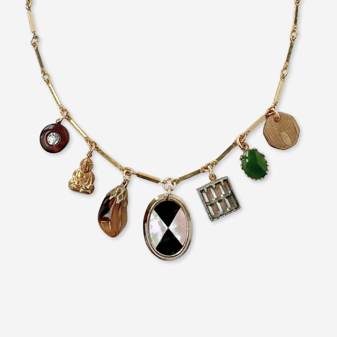 Repurposed vintage mixed charm necklace on gold bar chain