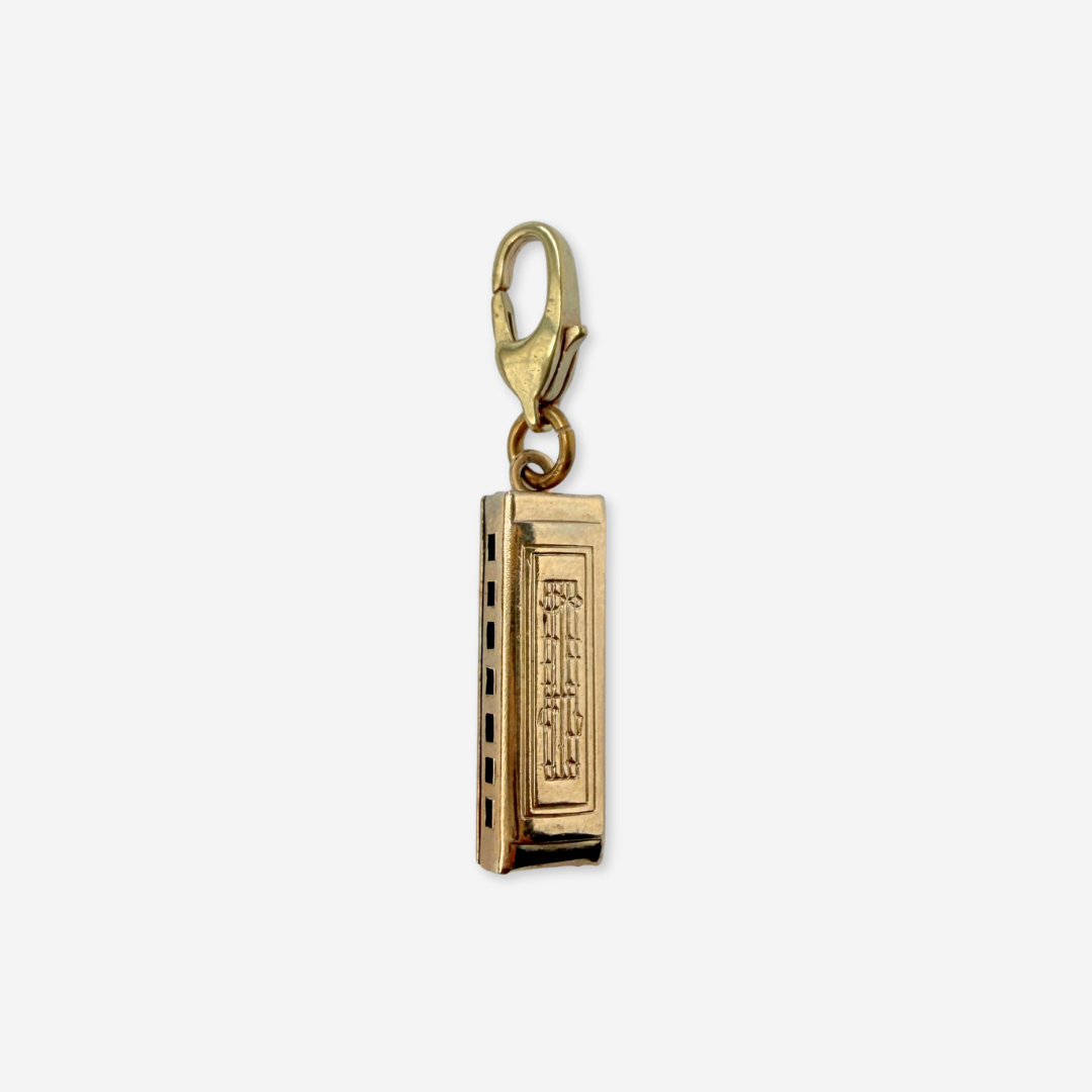 Vintage muted gold harmonica charm pendant