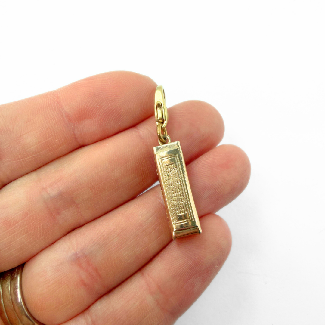 Vintage muted gold harmonica charm pendant