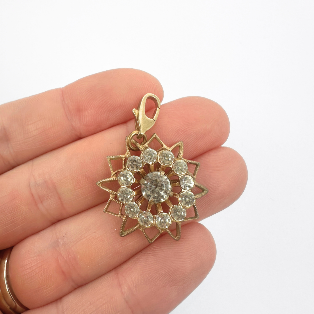 Vintage brass and clear rhinestone sunburst charm