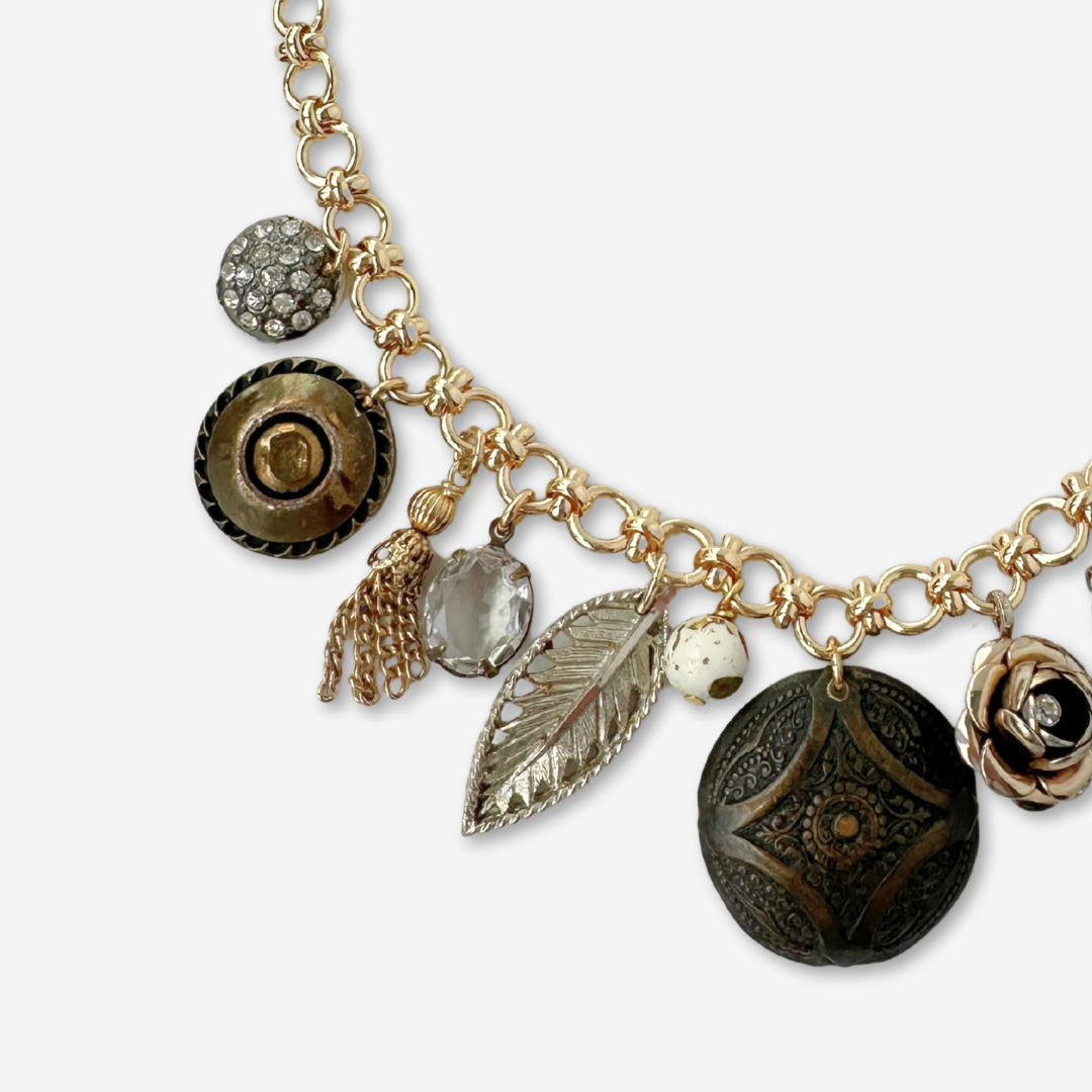 Repurposed vintage neutral charm necklace on gold plated chain