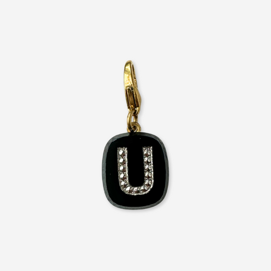 Black letter 'U' charm with gold clasp on a white background