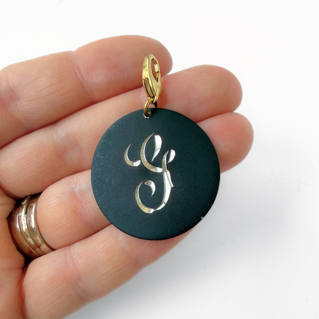 Large vintage black matte circular "G" monogram charm
