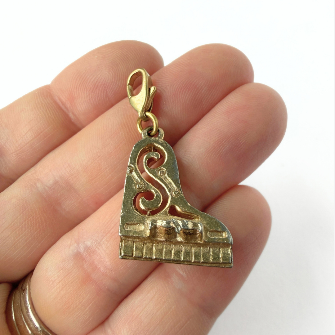 Vintage muted gold tone piano charm