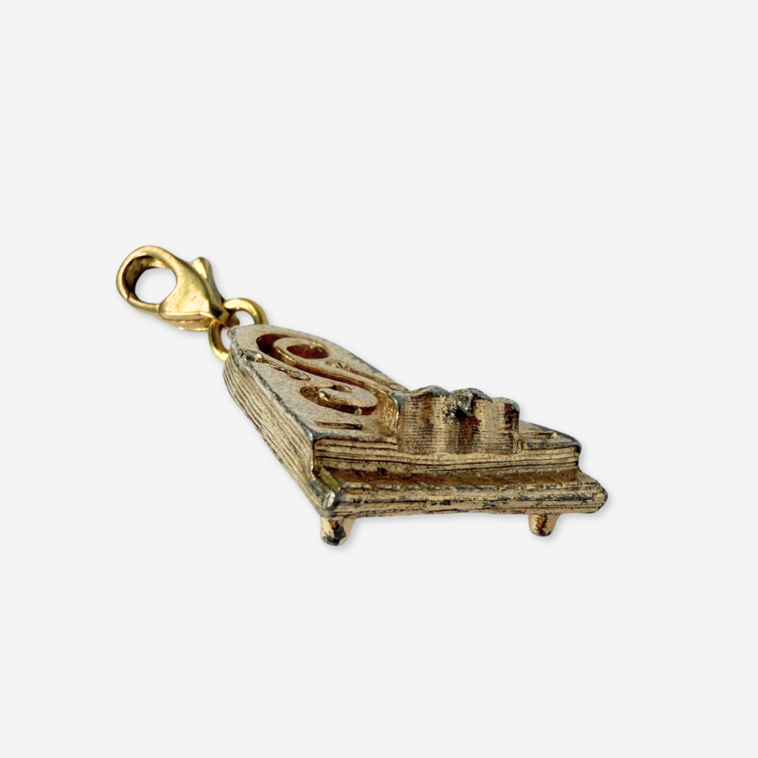 Vintage muted gold tone piano charm