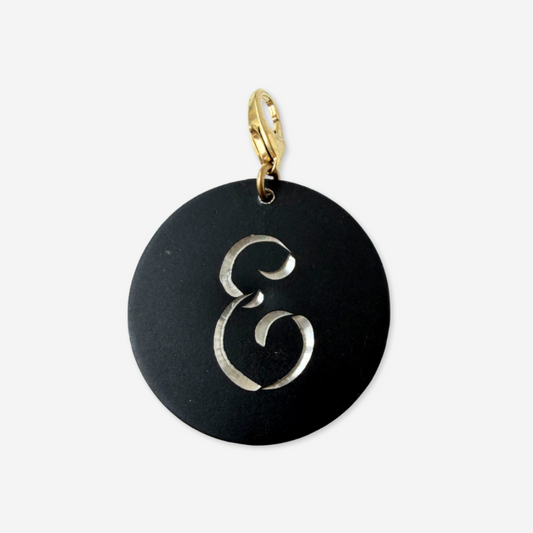 Large vintage black matte circular "E" monogram charm
