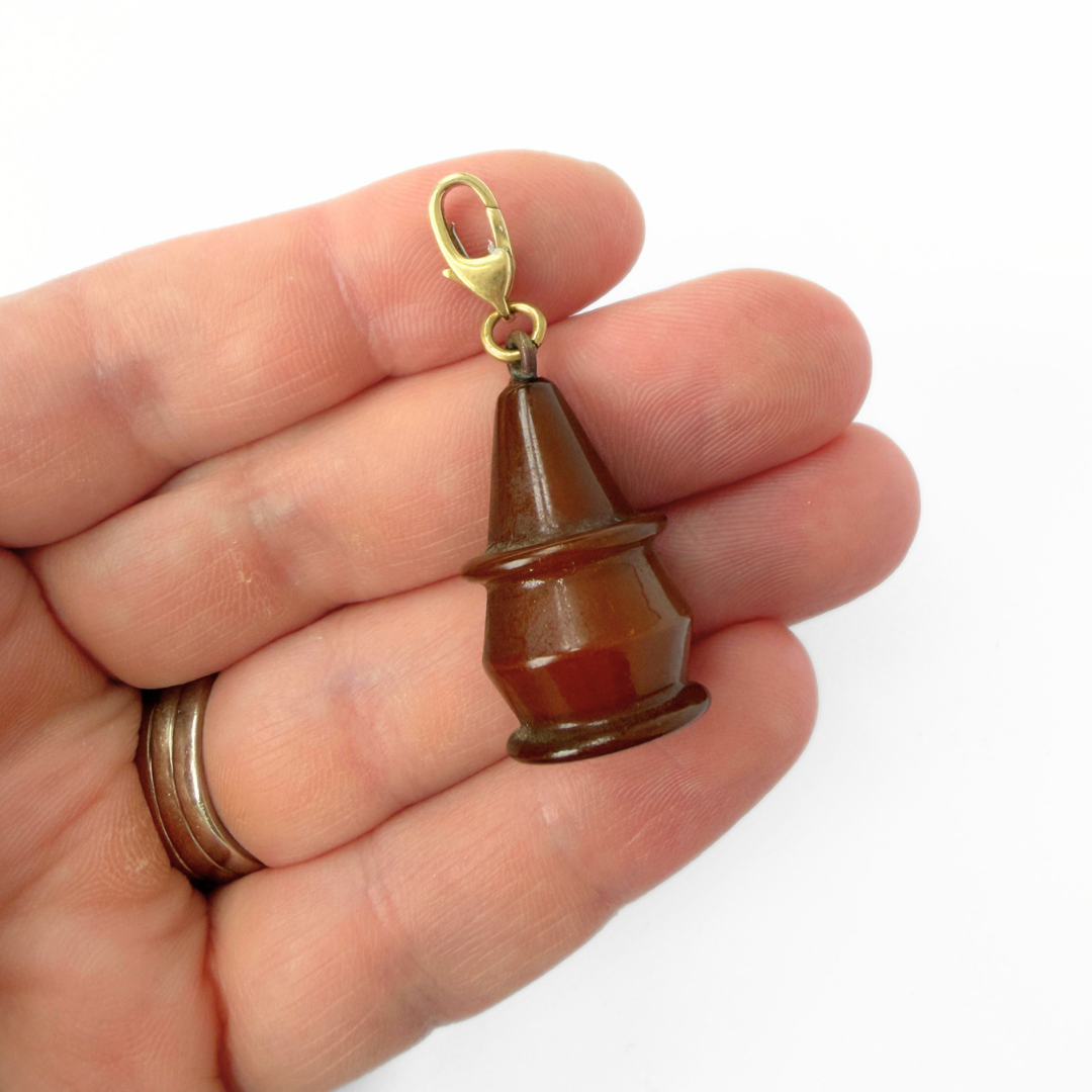 Vintage brown celluloid cone charm