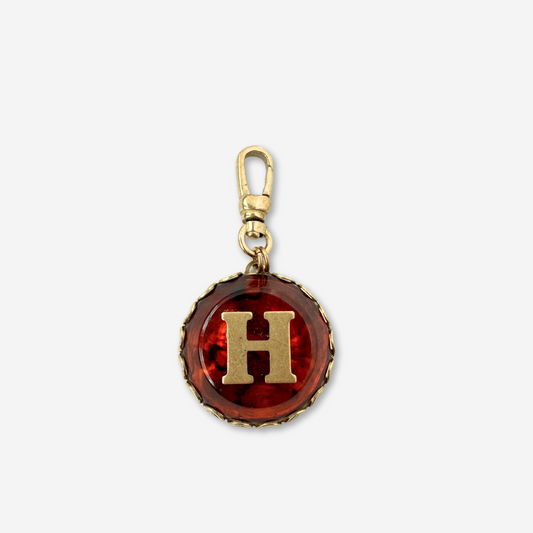 Vintage round tortoise shell and brass "H" charm