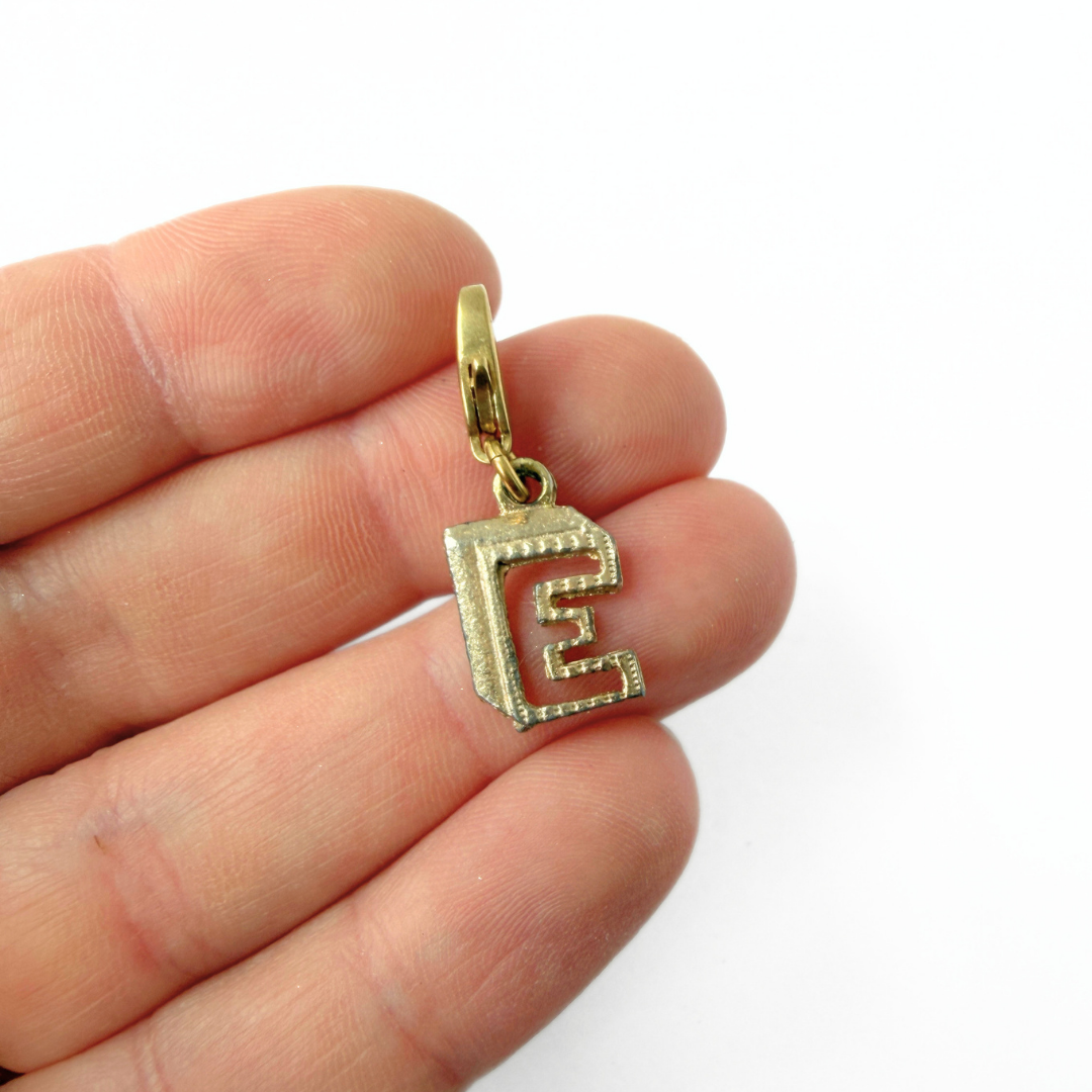 Small vintage gold tone cutout "E" monogram charm