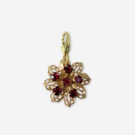 Vintage brass filigree flower charm with purple rhinestones