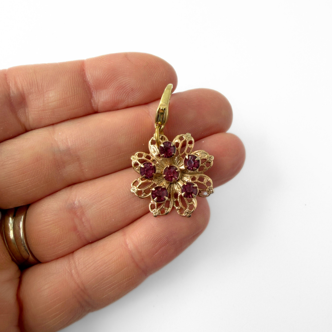 Vintage brass filigree flower charm with purple rhinestones