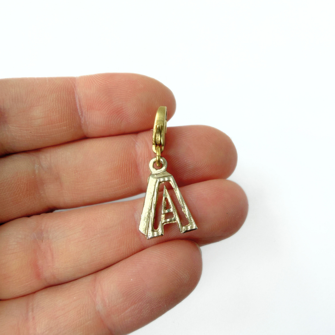 Small vintage gold tone cutout "A" monogram charm