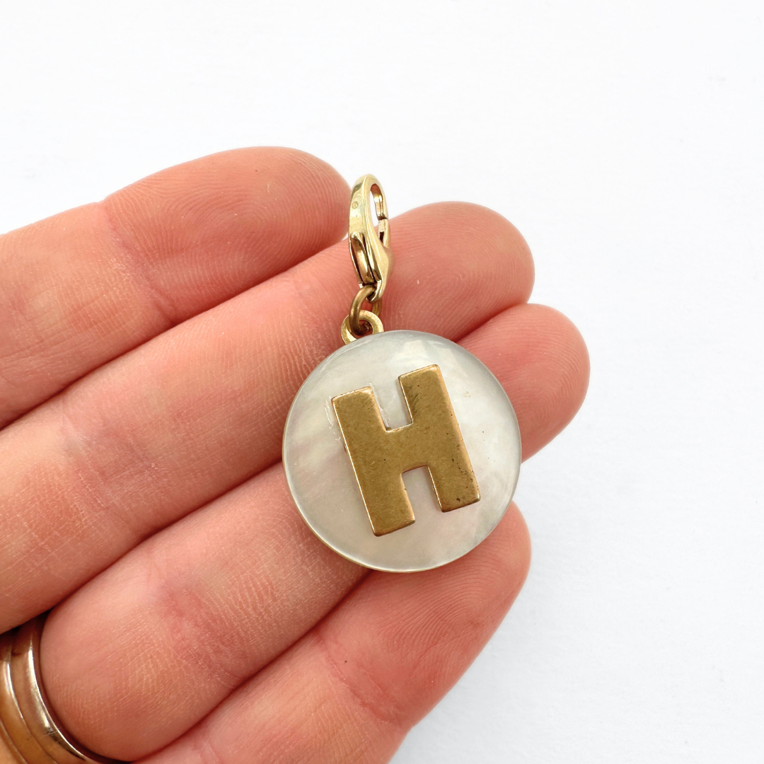 Vintage mother of pearl and brass "H" monogram circular charm