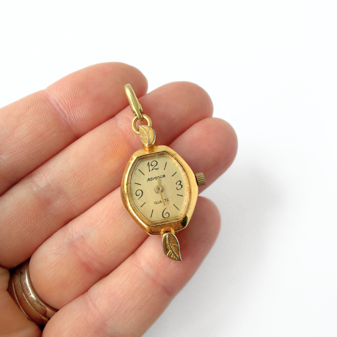 Vintage gold plated "Advance" watch face charm
