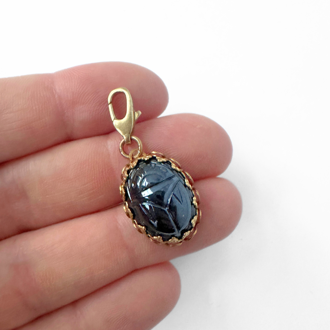 Vintage carved hematite scarab charm in brass setting