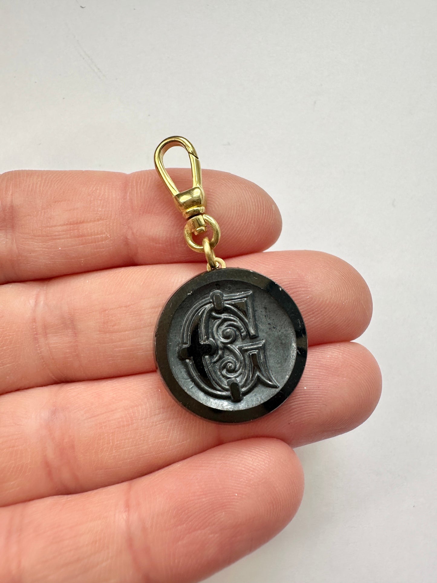 Vintage black glass orante letter "G" circular charm