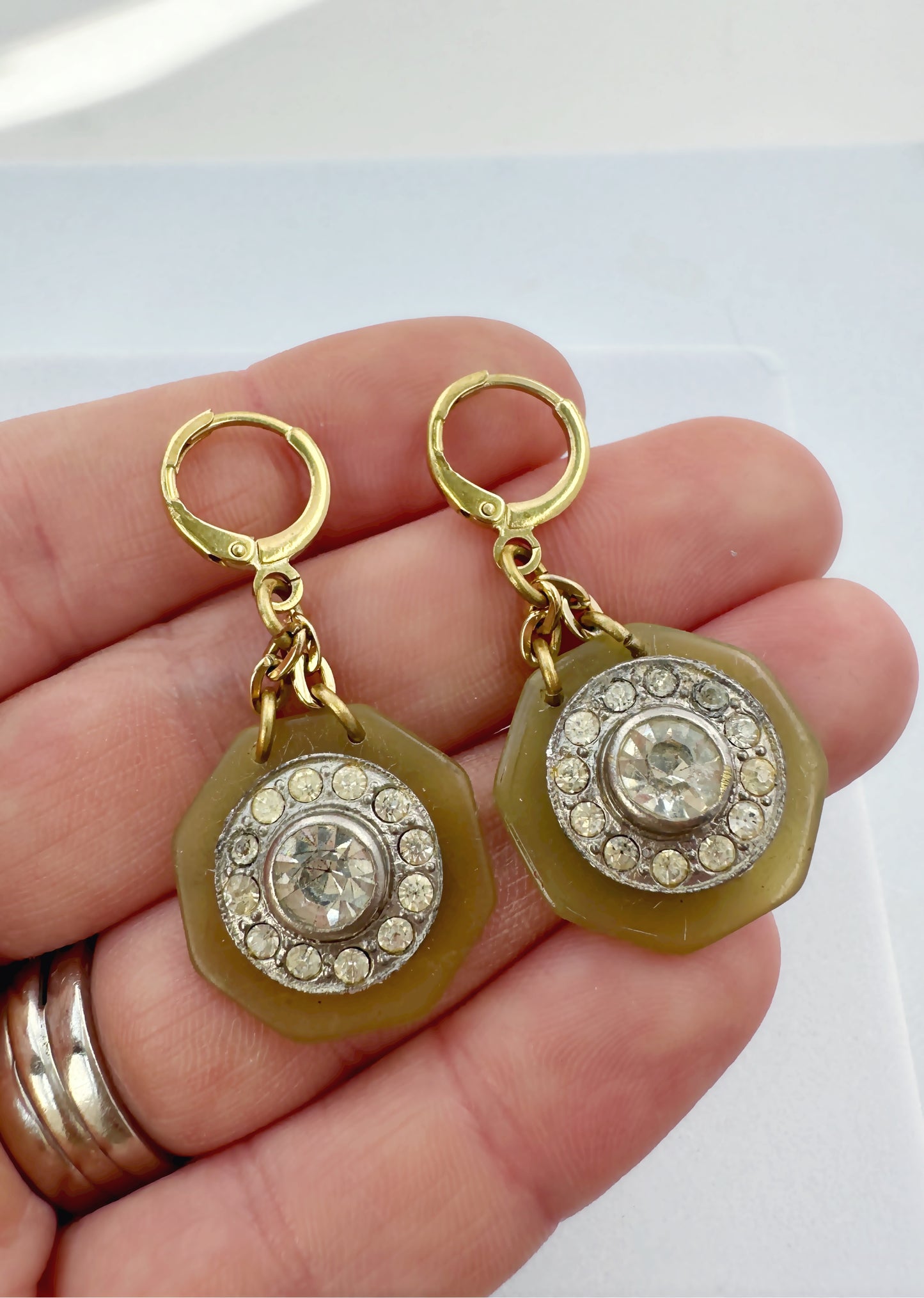 Repurposed vintage olive green button earrings with clear rhinestone centers and brass lever backs