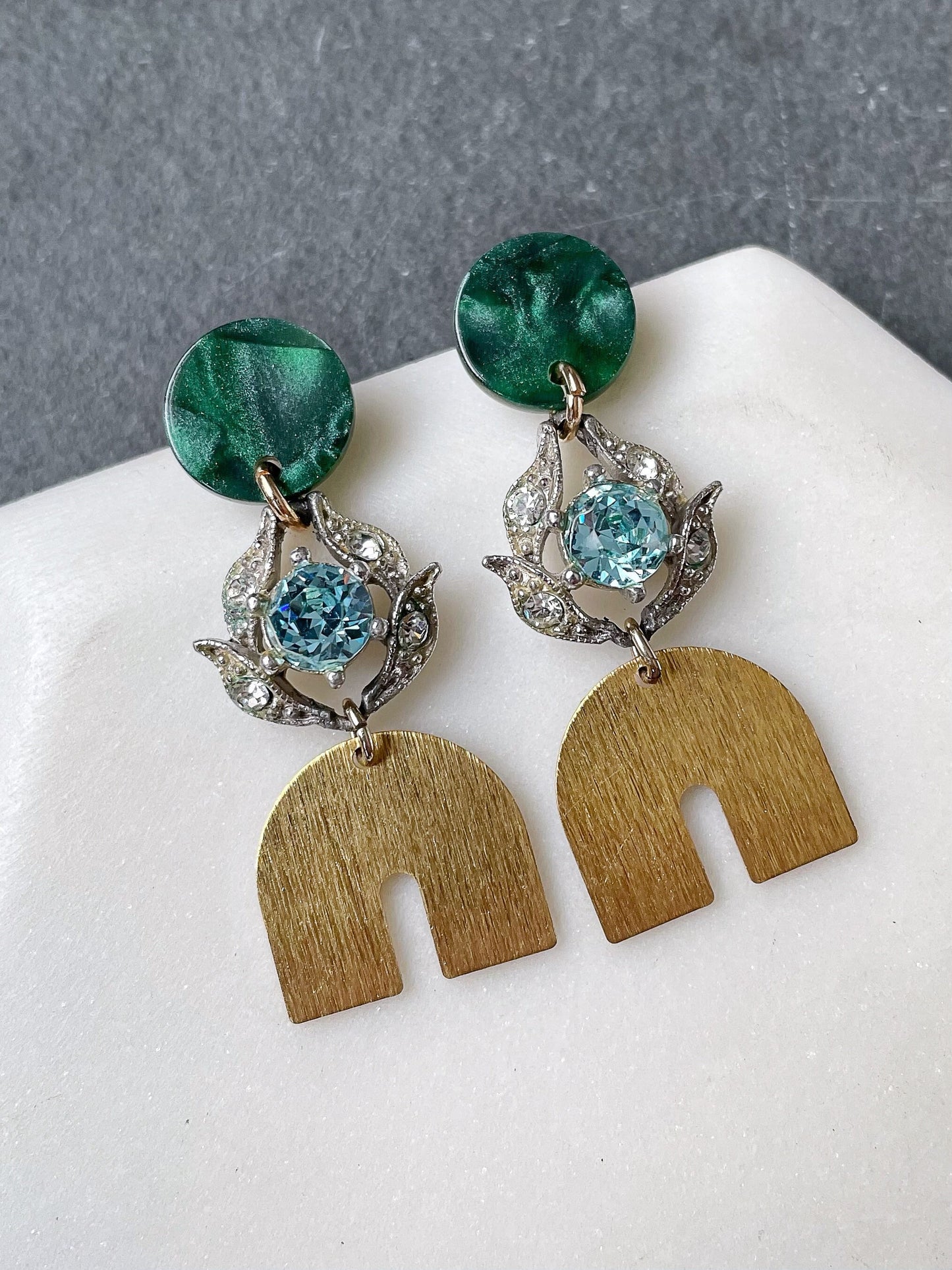 Vintage aqua rhinestone earrings with brass rainbow and green post